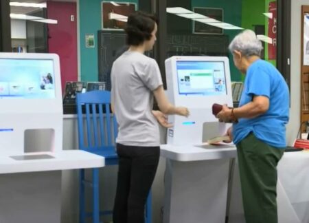 How does RFID automation reduce wait times for library users, especially during peak hours